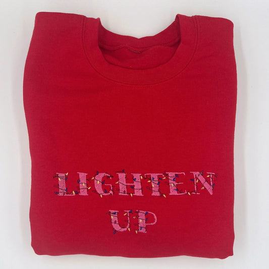 Embroidered "lighten up" unisex Christmas sweatshirt